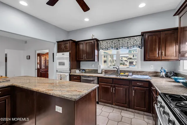a kitchen with a stove sink and cabinets
