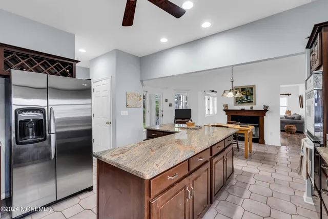 a living room with stainless steel appliances kitchen island furniture and a view of kitchen