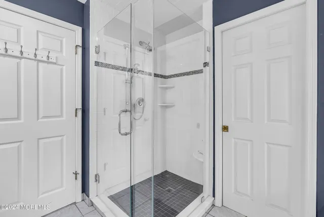 a bathroom with a glass shower door