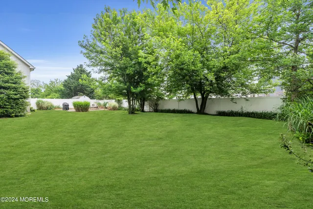 a view of a garden with a building in the background