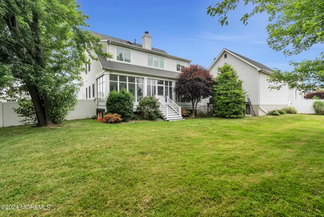 a front view of house with yard and green space