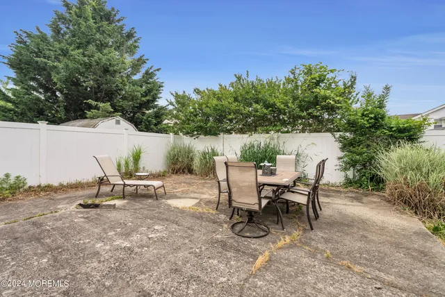 a view of a backyard with a table and chairs