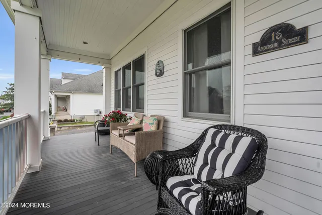 a view of a patio with dining table and chairs