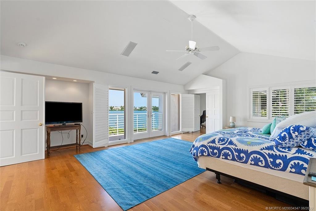 2421 Bahia Way Stuart, FL 34996 - Photo 15 of 83 a bedroom with a bed and a flat screen tv