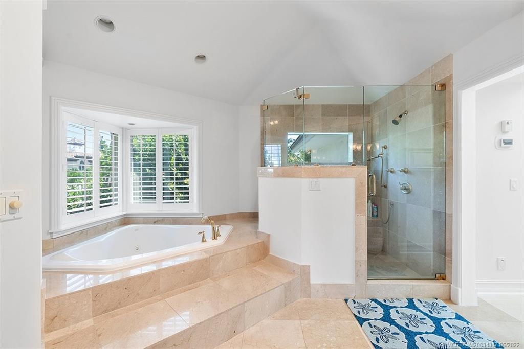 2421 Bahia Way Stuart, FL 34996 - Photo 17 of 83 a spacious bathroom with a bathtub and a shower