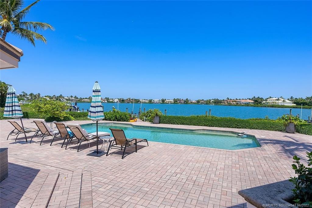 2421 Bahia Way Stuart, FL 34996 - Photo 38 of 83 a view of a swimming pool and lounge chairs