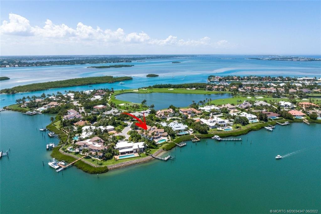 2421 Bahia Way Stuart, FL 34996 - Photo 45 of 83 a view of a lake with lawn chairs