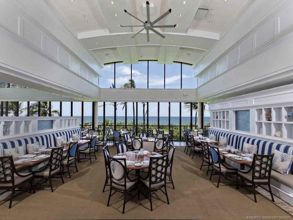 2421 Bahia Way Stuart, FL 34996 - Photo 59 of 83 a dining room with furniture a chandelier and a ceiling fan