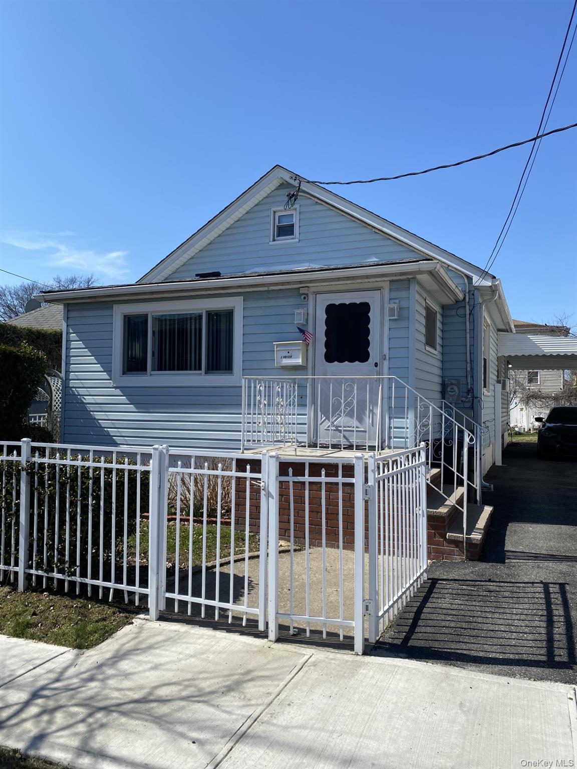 145-24 223rd Street Queens, NY 11413 - Photo 1 of 16 a front view of a house with wooden fence