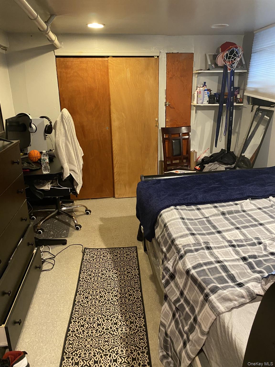 145-24 223rd Street Queens, NY 11413 - Photo 12 of 16 a bed sitting in a bedroom next to a window