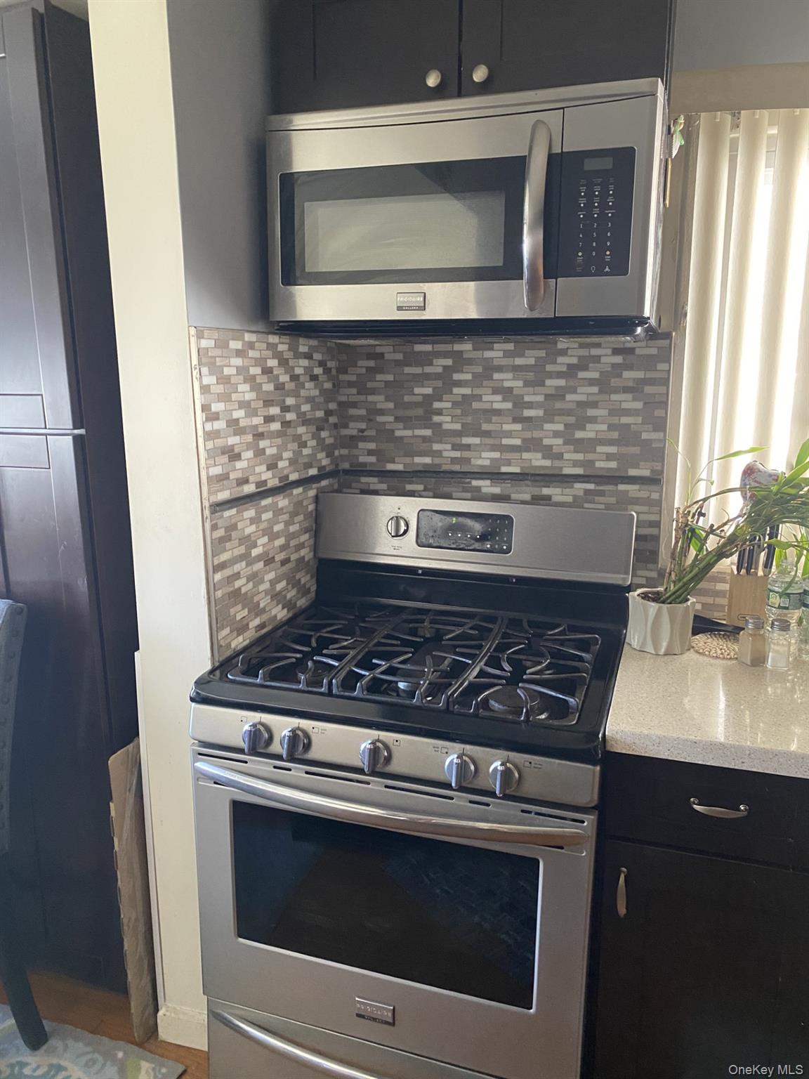 145-24 223rd Street Queens, NY 11413 - Photo 14 of 16 a stove top oven sitting inside of a kitchen