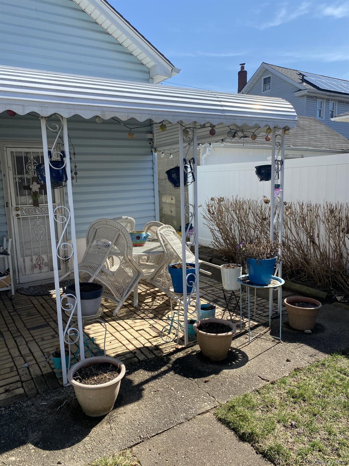 145-24 223rd Street Queens, NY 11413 - Photo 9 of 16 a view of a patio with table and chairs