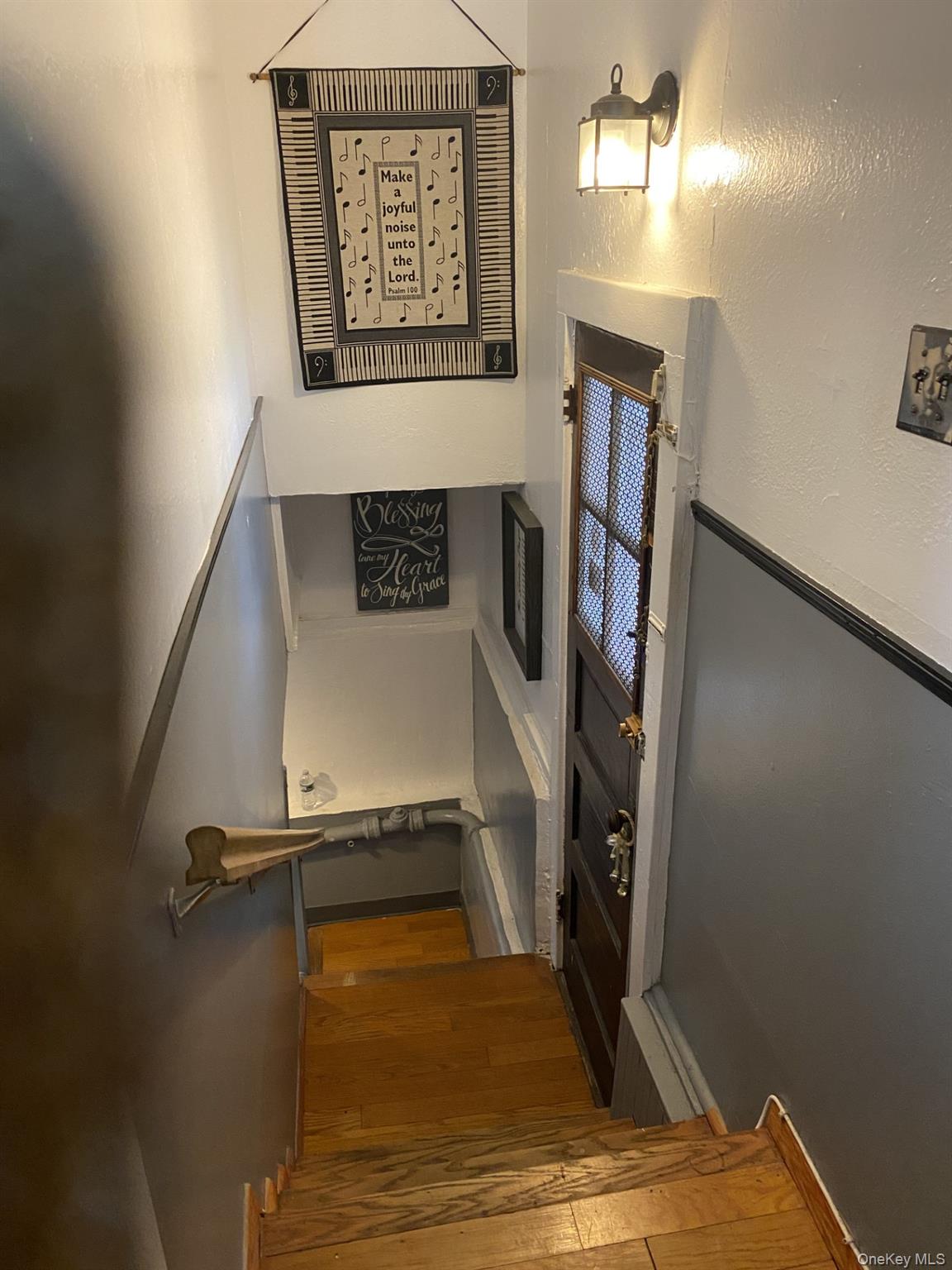 145-24 223rd Street Queens, NY 11413 - Photo 10 of 16 a view of a room with wooden floor and staircase