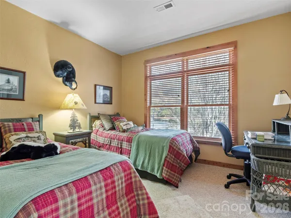a bedroom with two beds and a window