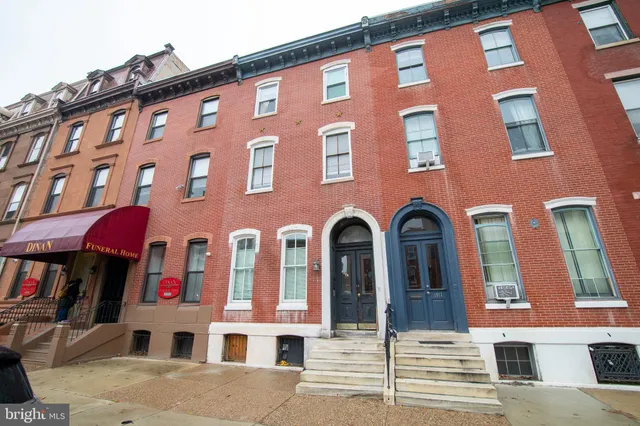 a front view of a building with large windows