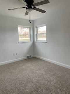 106 Larry Street Aliquippa, PA 15001 - Photo 13 of 14 en empty room with windows and ceiling fan