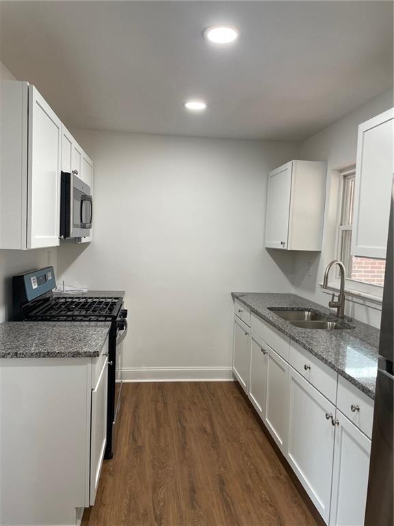 106 Larry Street Aliquippa, PA 15001 - Photo 6 of 14 a kitchen with granite countertop a sink stove and cabinets