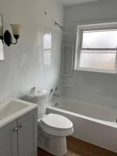 a bathroom with a toilet a sink and bathtub