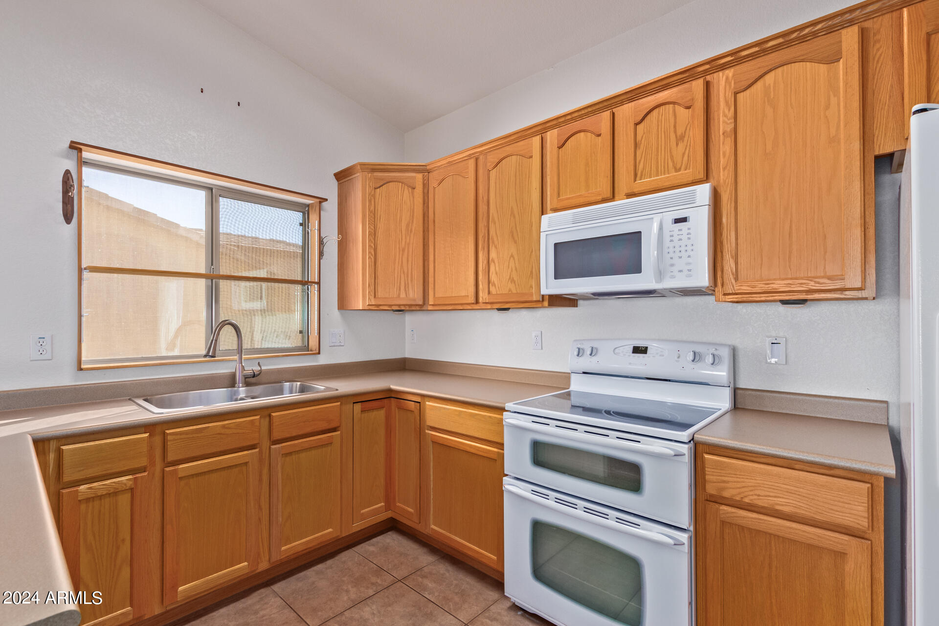 2101 South Meridian Road, Unit 172 Apache Junction, AZ 85120 - Photo 24 of 43 a kitchen with cabinets appliances a sink and a window