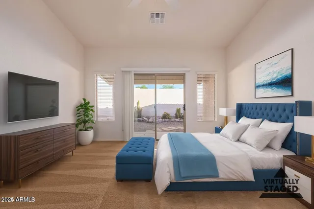 a spacious bedroom with a large bed and a flat screen tv