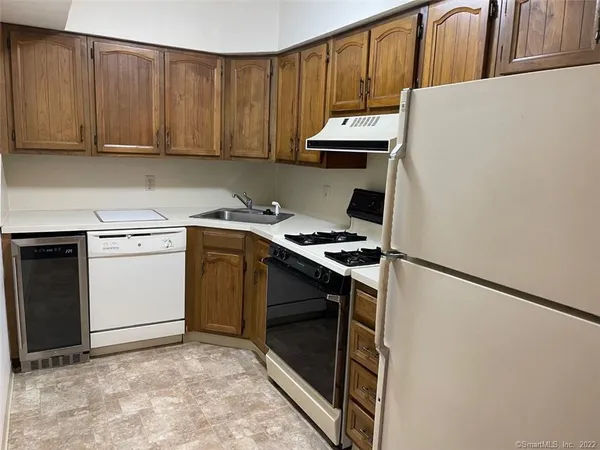 a kitchen with a stove a sink and a refrigerator