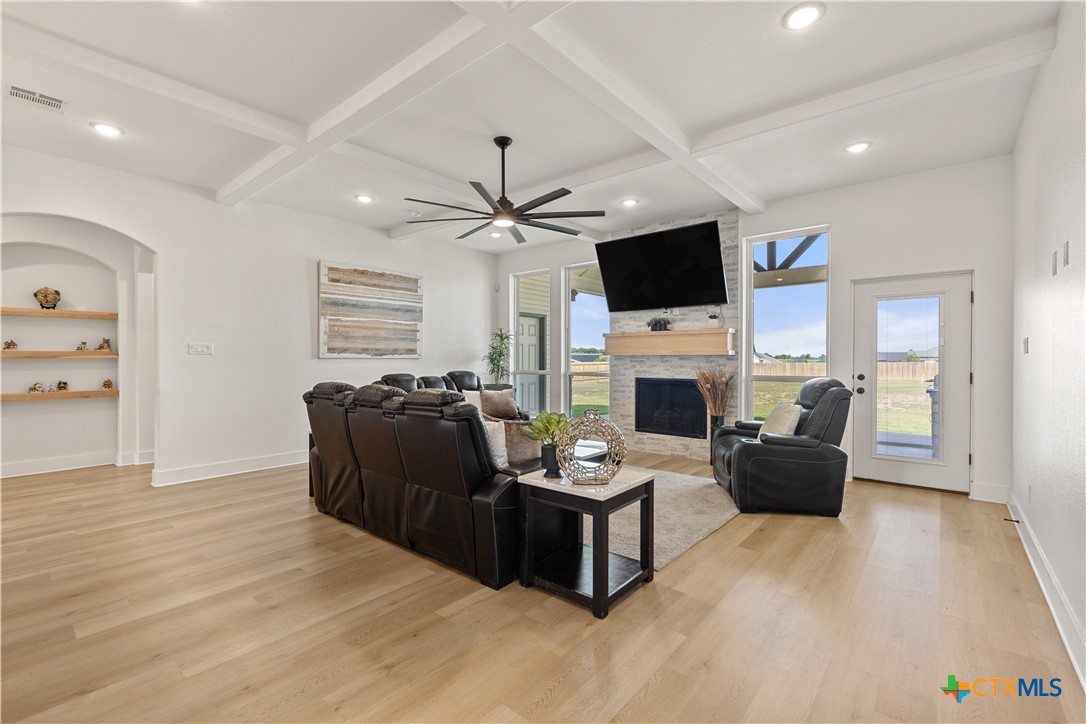 942 Inka Road Salado, TX 76571 - Photo 16 of 46 a living room with furniture a flat screen tv and a fireplace