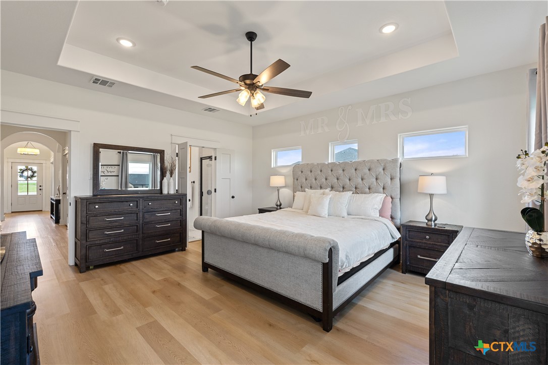 942 Inka Road Salado, TX 76571 - Photo 18 of 46 a spacious bedroom with a bed and a dresser