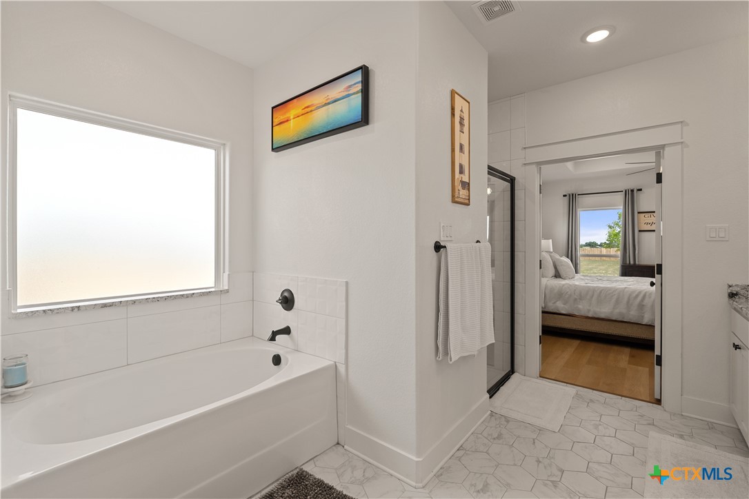942 Inka Road Salado, TX 76571 - Photo 21 of 46 a en suite spacious bathroom with a tub and shower