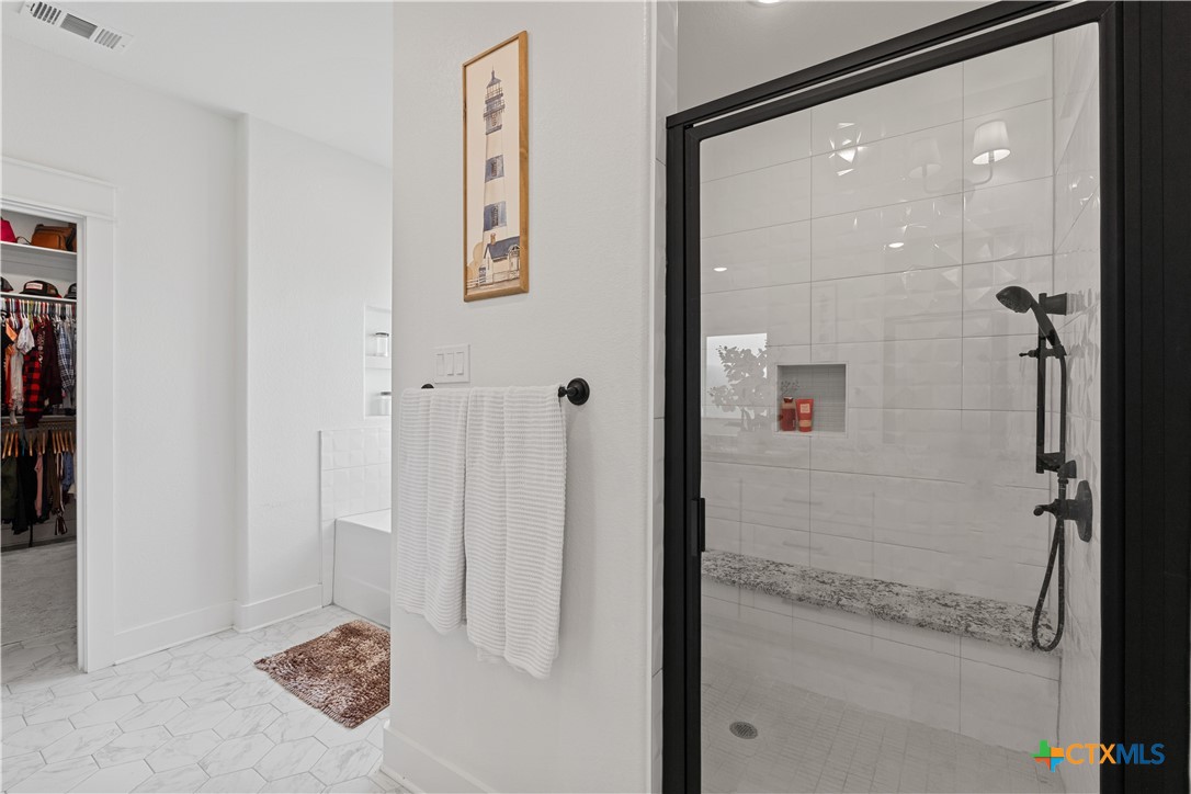 942 Inka Road Salado, TX 76571 - Photo 22 of 46 a bathroom with a glass shower door