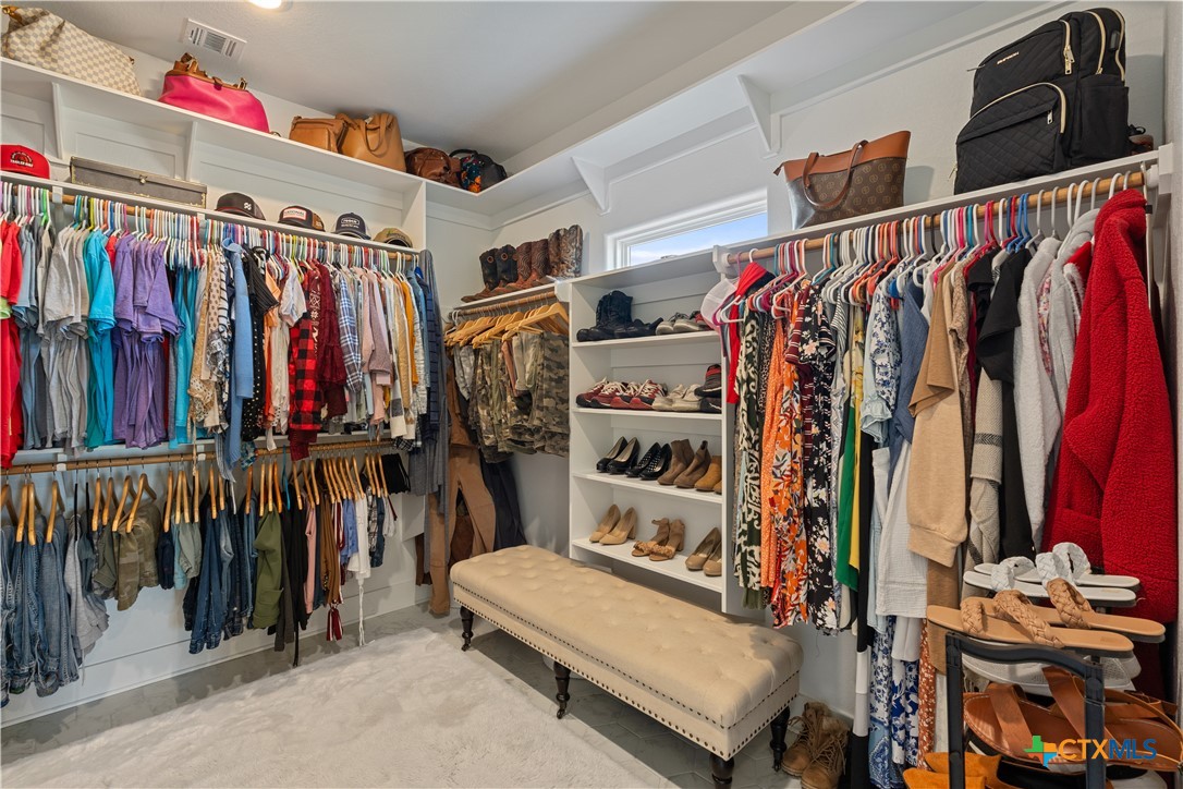 942 Inka Road Salado, TX 76571 - Photo 24 of 46 a view of walk in closet with clothes and shoes