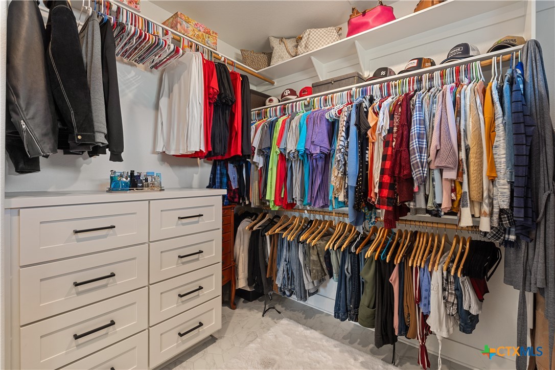 942 Inka Road Salado, TX 76571 - Photo 25 of 46 a view of walk in closet with clothes