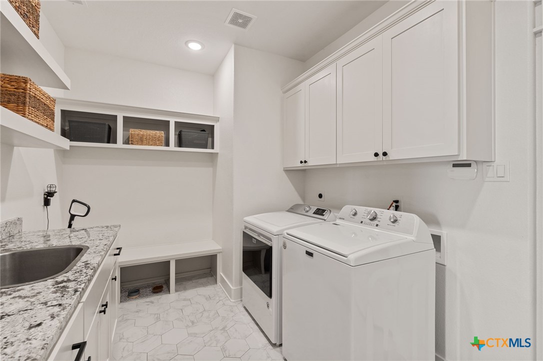 942 Inka Road Salado, TX 76571 - Photo 26 of 46 a utility room with sink dryer and washer