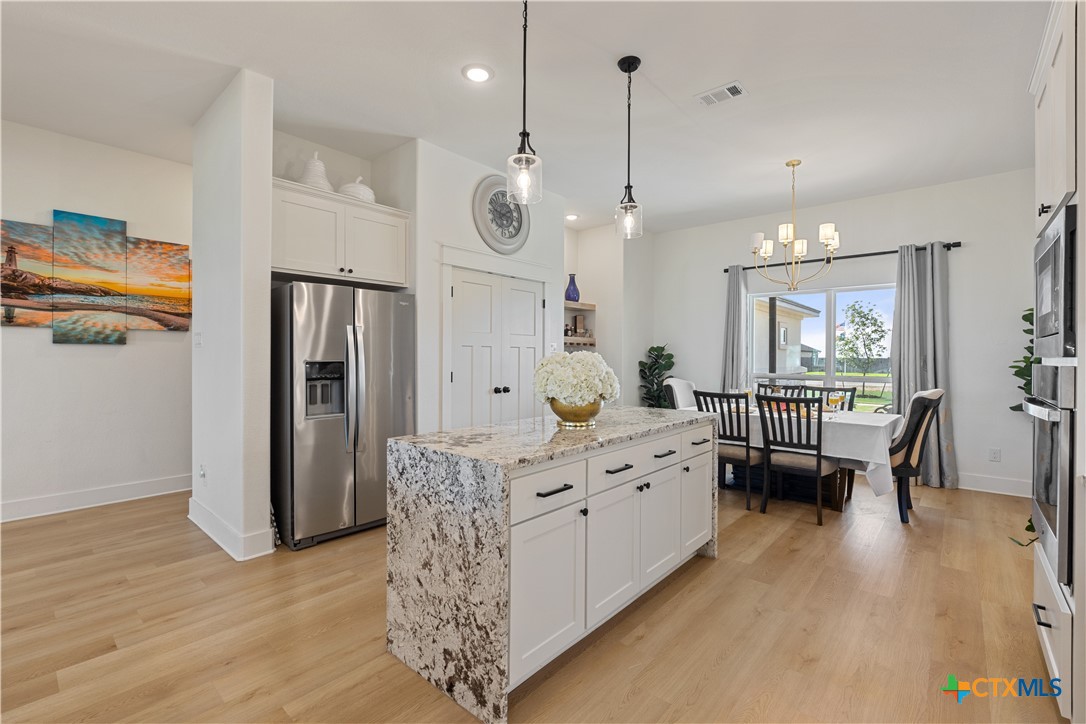 942 Inka Road Salado, TX 76571 - Photo 9 of 46 a large room with chandelier fan and wooden furniture