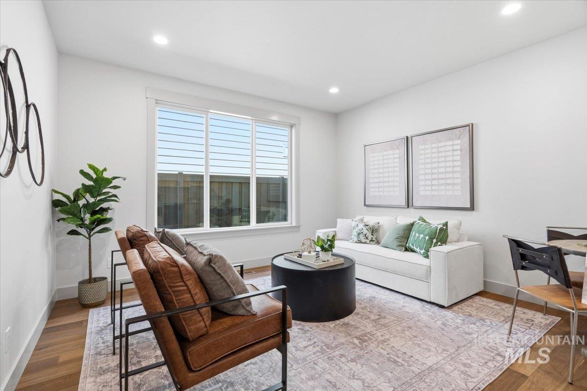6762 South Messner Way Meridian, ID 83642 - Photo 22 of 35 Bright living area featuring wood-finish flooring, recessed lighting, and a large window with horizontal blinds