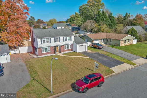 aerial view of a house with a yard