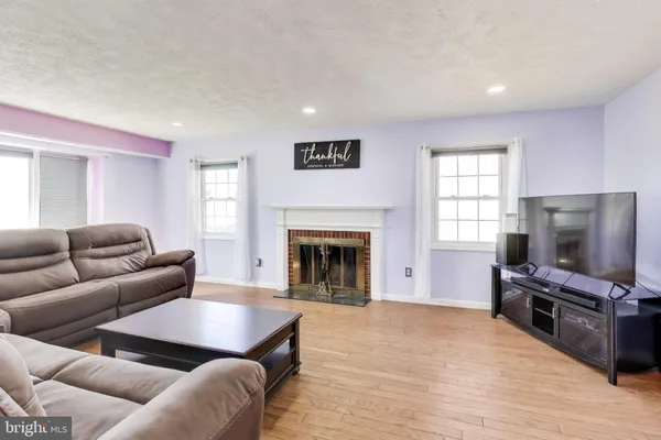 a living room with furniture flat screen tv and a fireplace