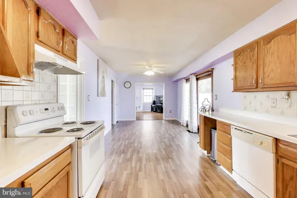 a kitchen with stainless steel appliances a stove sink and cabinets
