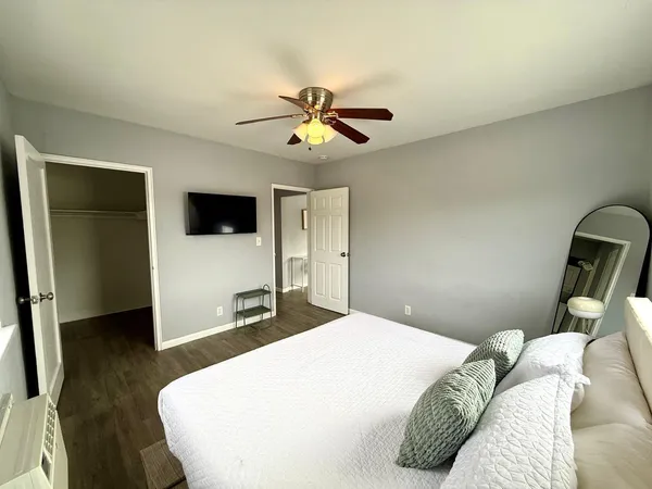 a bedroom with a bed and a flat screen tv