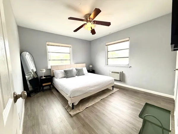 a bed room with a bed and a ceiling fan