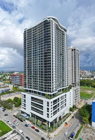 a front view of a building with a yard