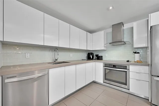 a kitchen with stainless steel appliances granite countertop a sink and cabinets