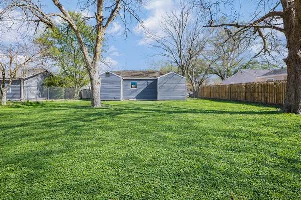 a view of a backyard with large trees