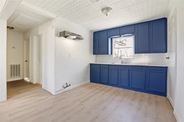 a kitchen with granite countertop wooden cabinets and white appliances
