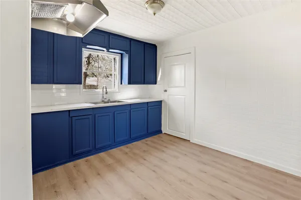 a view of kitchen with granite countertop cabinets and wooden floor