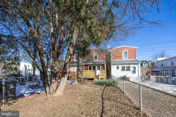 a view of a house with a tree in the background