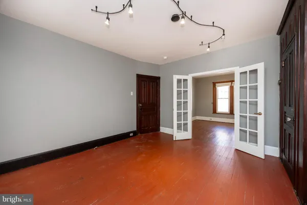 a view of a livingroom with wooden floor and a ceiling fan
