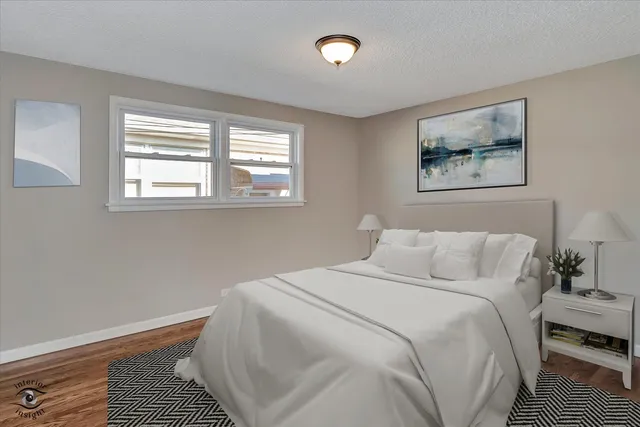 a bedroom with a bed and a painting on the wall