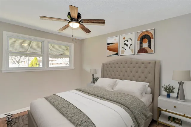 a bedroom with a bed and a painting on the wall