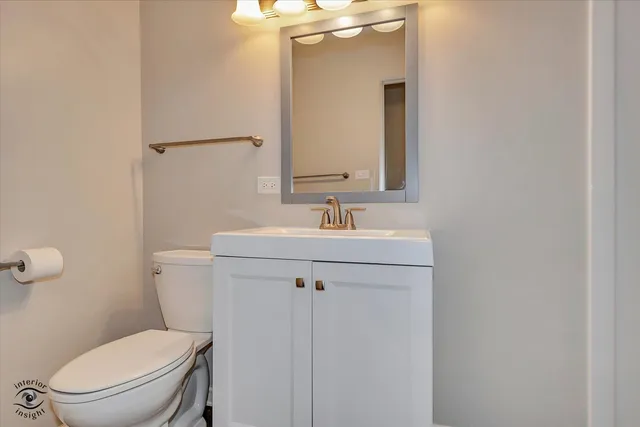 a bathroom with a sink a toilet and mirror