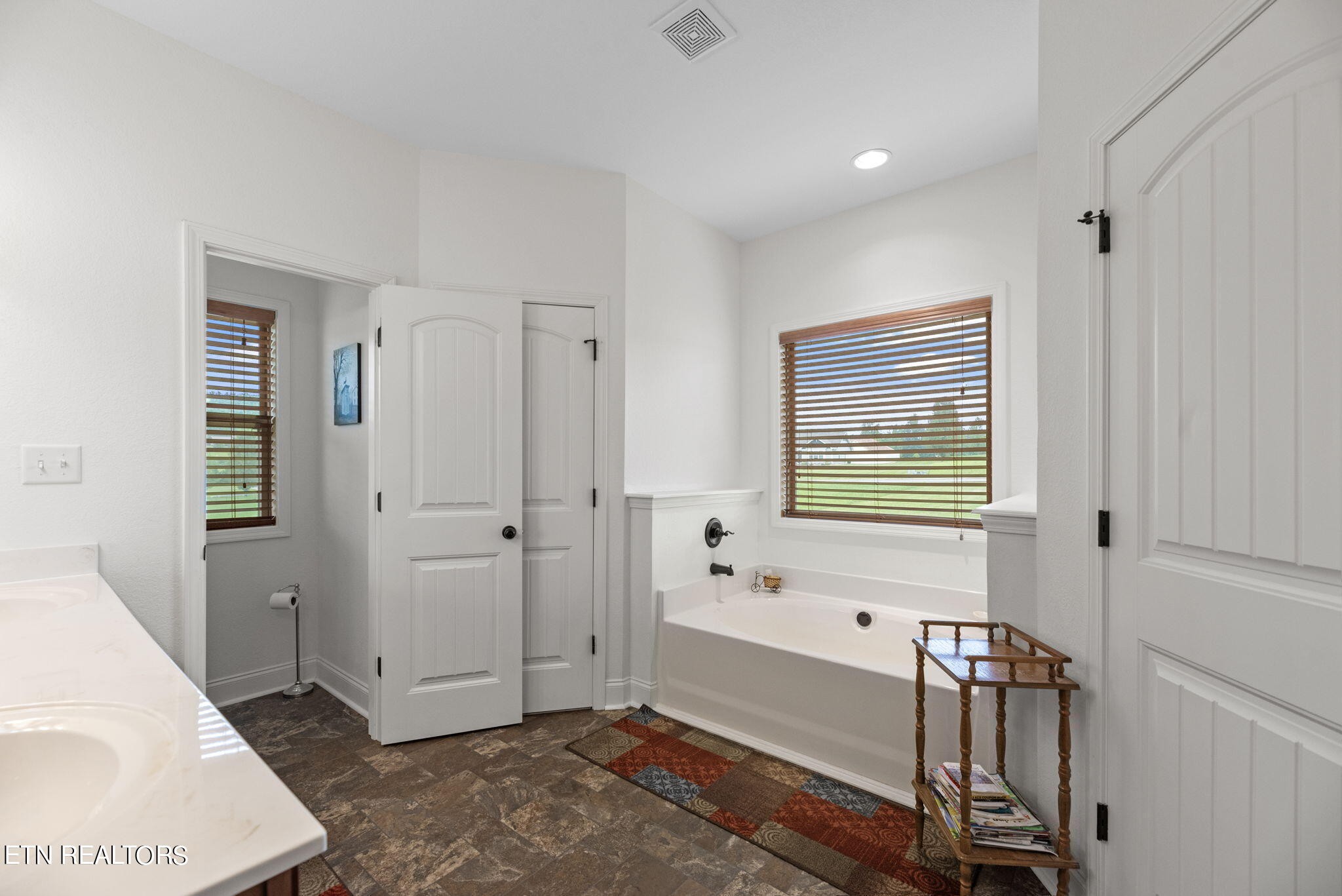 296 Shields Crossing Drive Bean Station, TN 37708 - Photo 15 of 52 a bathroom with a tub shower and a sink